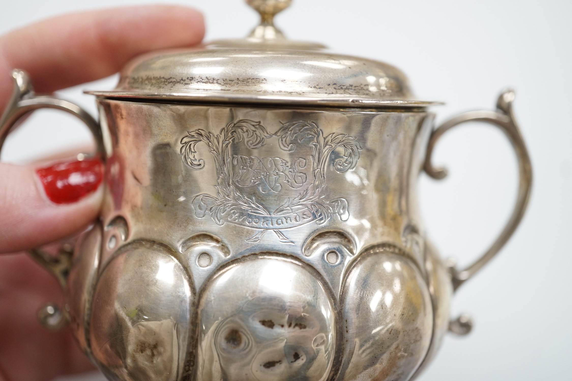 A George V silver presentation porringer and cover for the 'Rudge Motorcycle Sprint Race at Brooklands 13th of June 1912, third prize' William Comyns, height 10.5cm, 6.1oz.